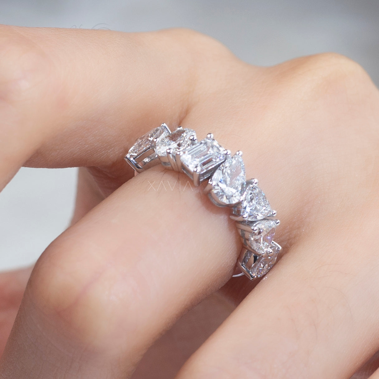 Multi shape lab diamond ring featuring pear, emerald, and oval cuts